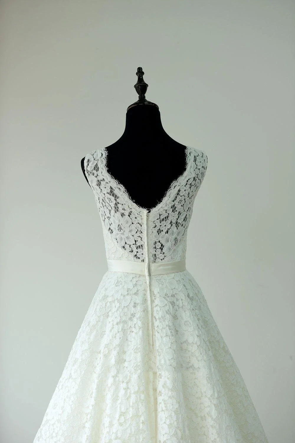 Back view of a tea length wedding dress with lace neckline.