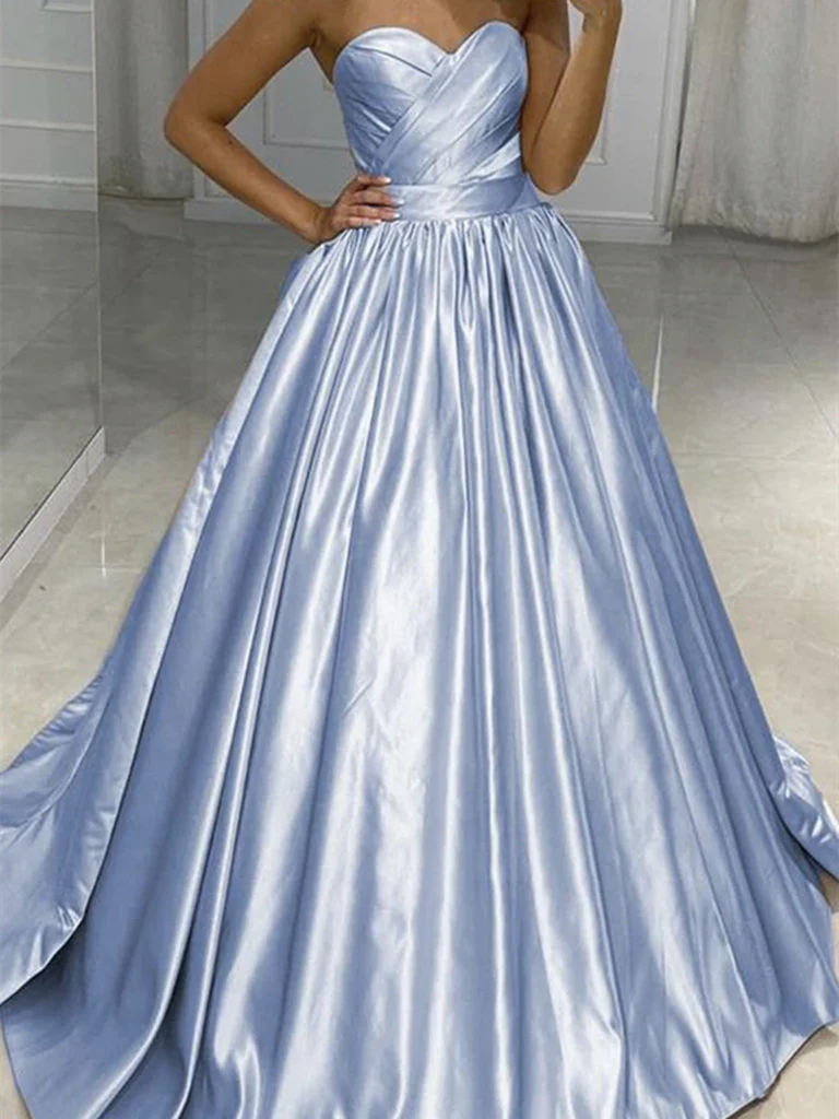 Woman wearing an elegant A-line sweetheart neck satin long prom dress.