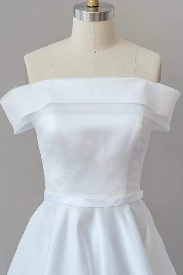 Close-up of the luxurious satin fabric and off-shoulder detail.