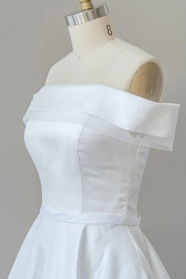 Bride wearing a graceful A-line off-shoulder satin wedding gown.