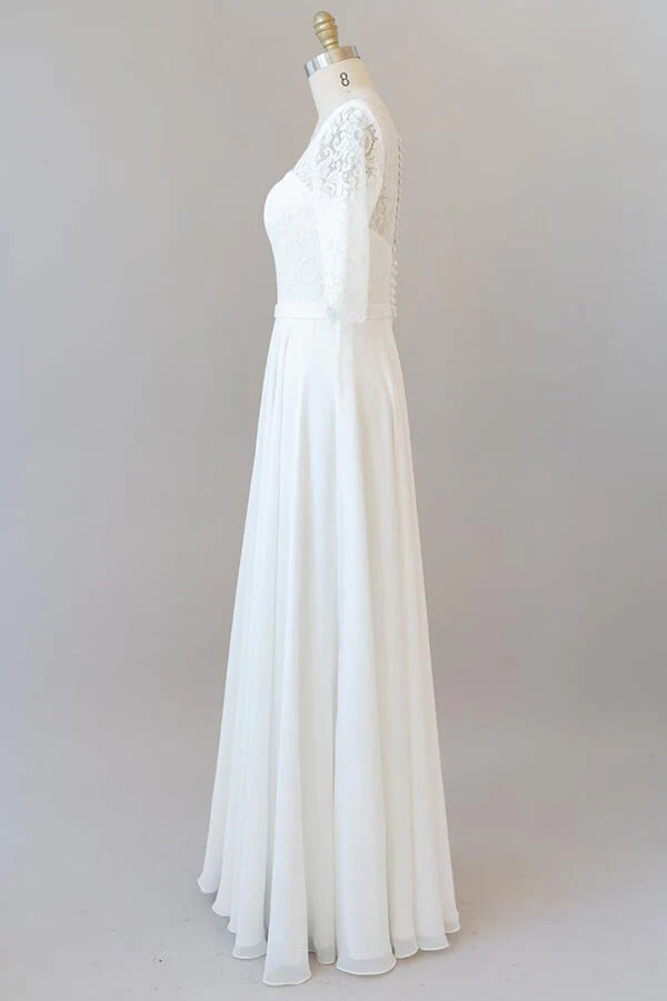 Close-up of the delicate lace and chiffon fabric on the wedding dress.