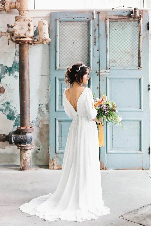 Side view of an elegant A-line V-neck chiffon bridal gown.