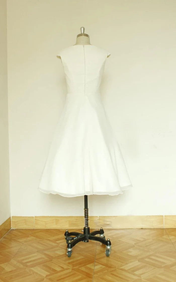 Front view of a graceful V-neck sleeveless tea-length satin wedding dress.