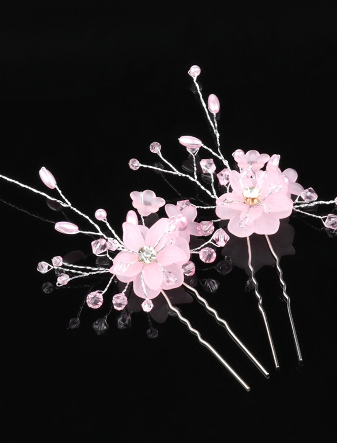 Close-up of a bridal floral hairpin featuring intricate white blooms.