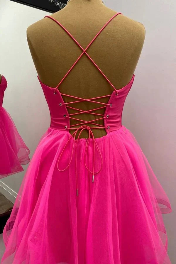 Model wearing a hot pink A-line homecoming dress, side view.
