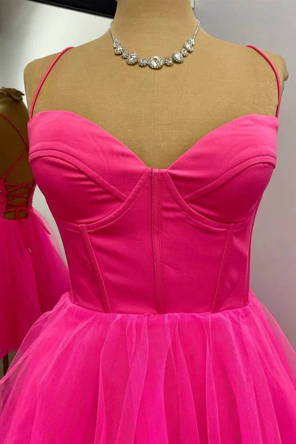 Back view of hot pink A-line homecoming dress showing lace-up detail.