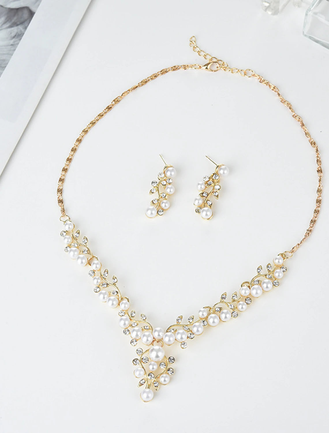 Close-up of imitation pearl hoop earring.