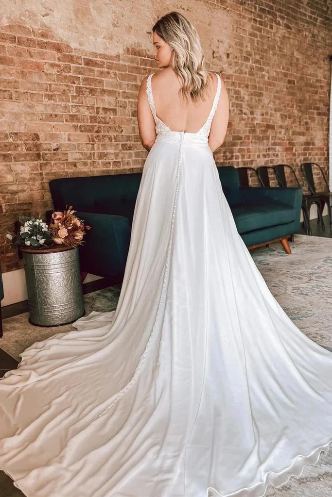 Side view of the ivory A-line floral lace wedding dress.