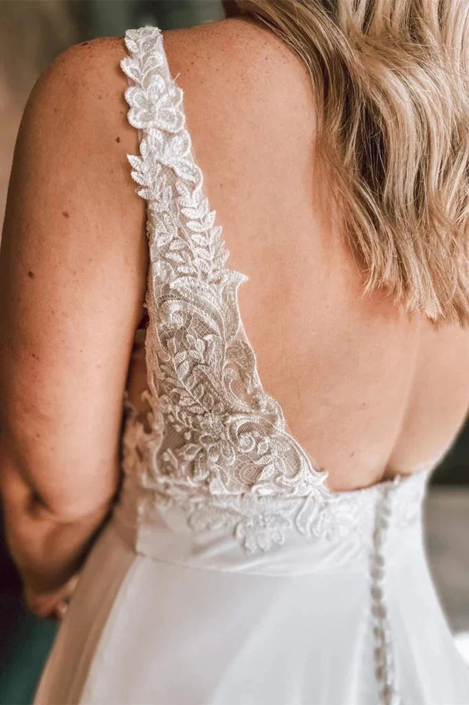 Full length view of the elegant ivory A-line floral lace wedding dress.