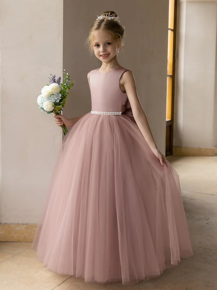 Ivory tulle ball gown flower girl dress with pearls and a satin bowknot.