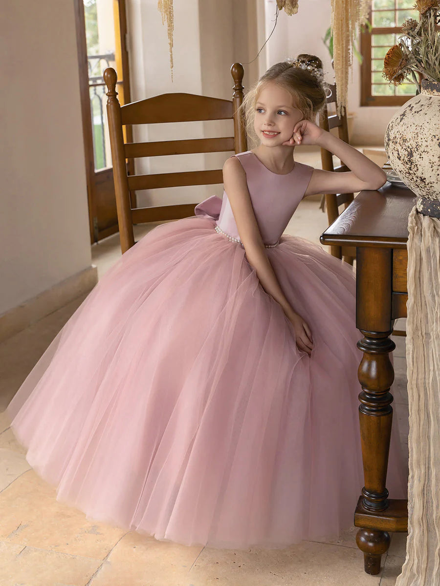 Side view of ivory tulle flower girl dress with full skirt.