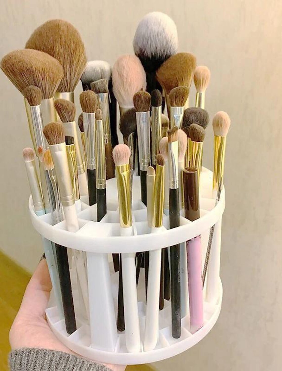 Round plastic makeup brush holder with 49 grids.