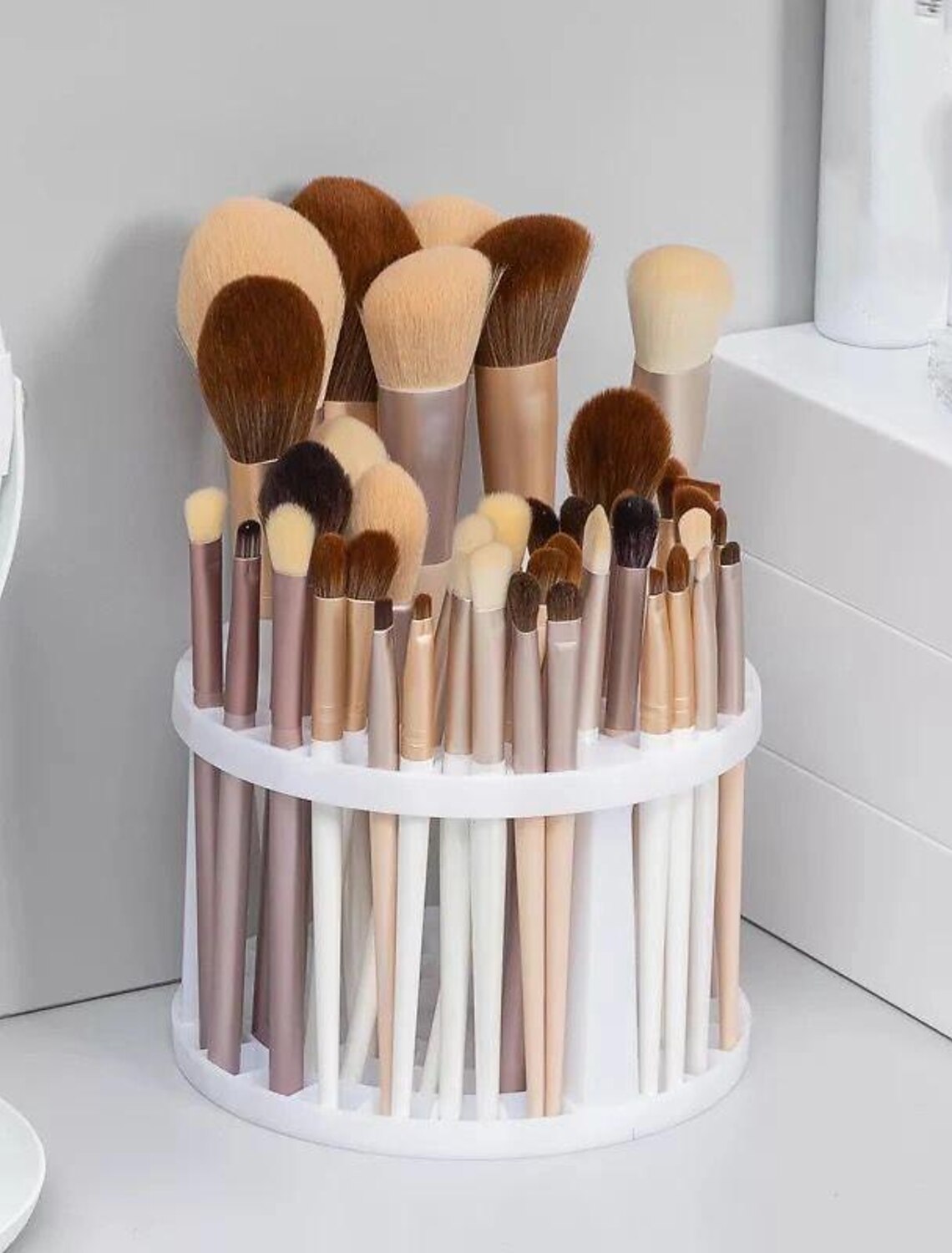 Empty round makeup brush and pen storage rack.