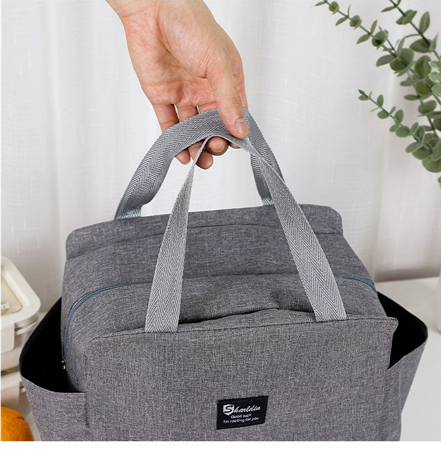 Insulated lunch bag with a water bottle and food containers.