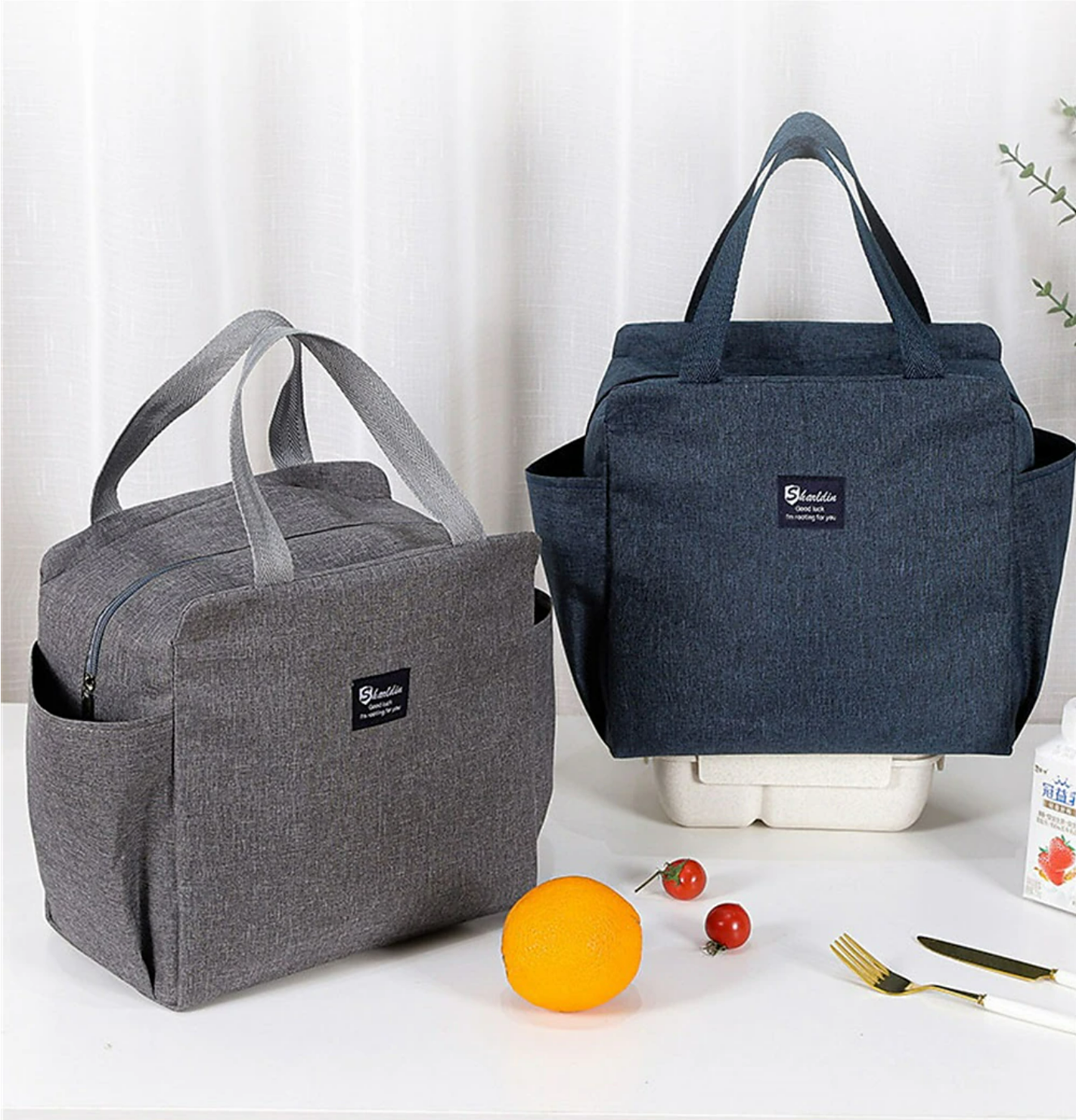 Person carrying a stylish insulated lunch bag.