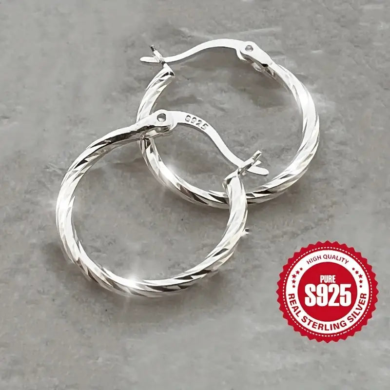 Close-up of a single S925 Sterling Silver twisted hoop earring.