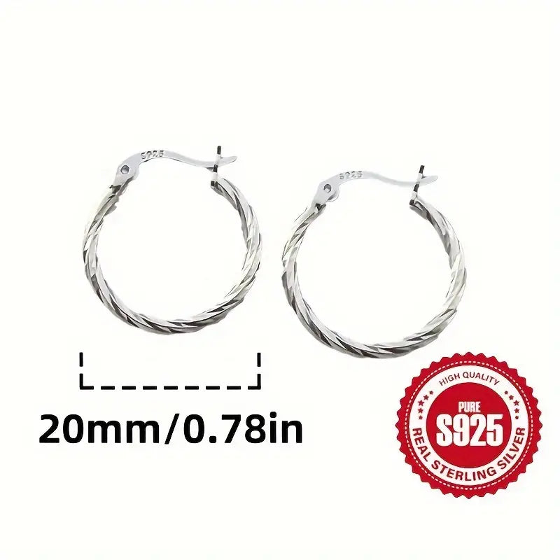 S925 Sterling Silver twisted hoop earrings displayed on an ear.