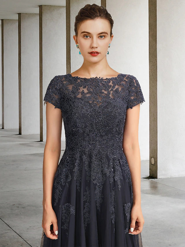 Side view of an elegant ball gown mother of the bride dress, showcasing the lace and tulle fabric with intricate crystal.