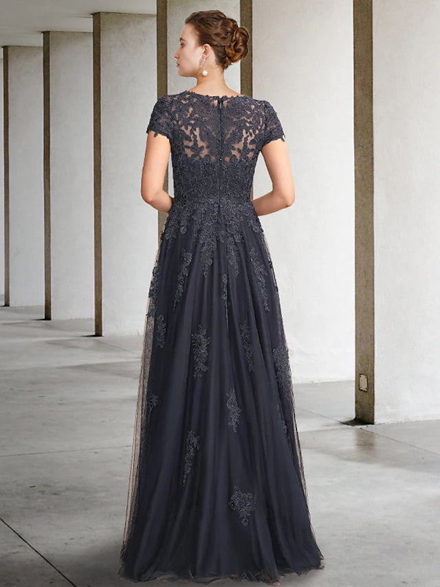 Back view of a sophisticated floor-length mother of the bride dress, highlighting the ball gown silhouette and short sleeves.