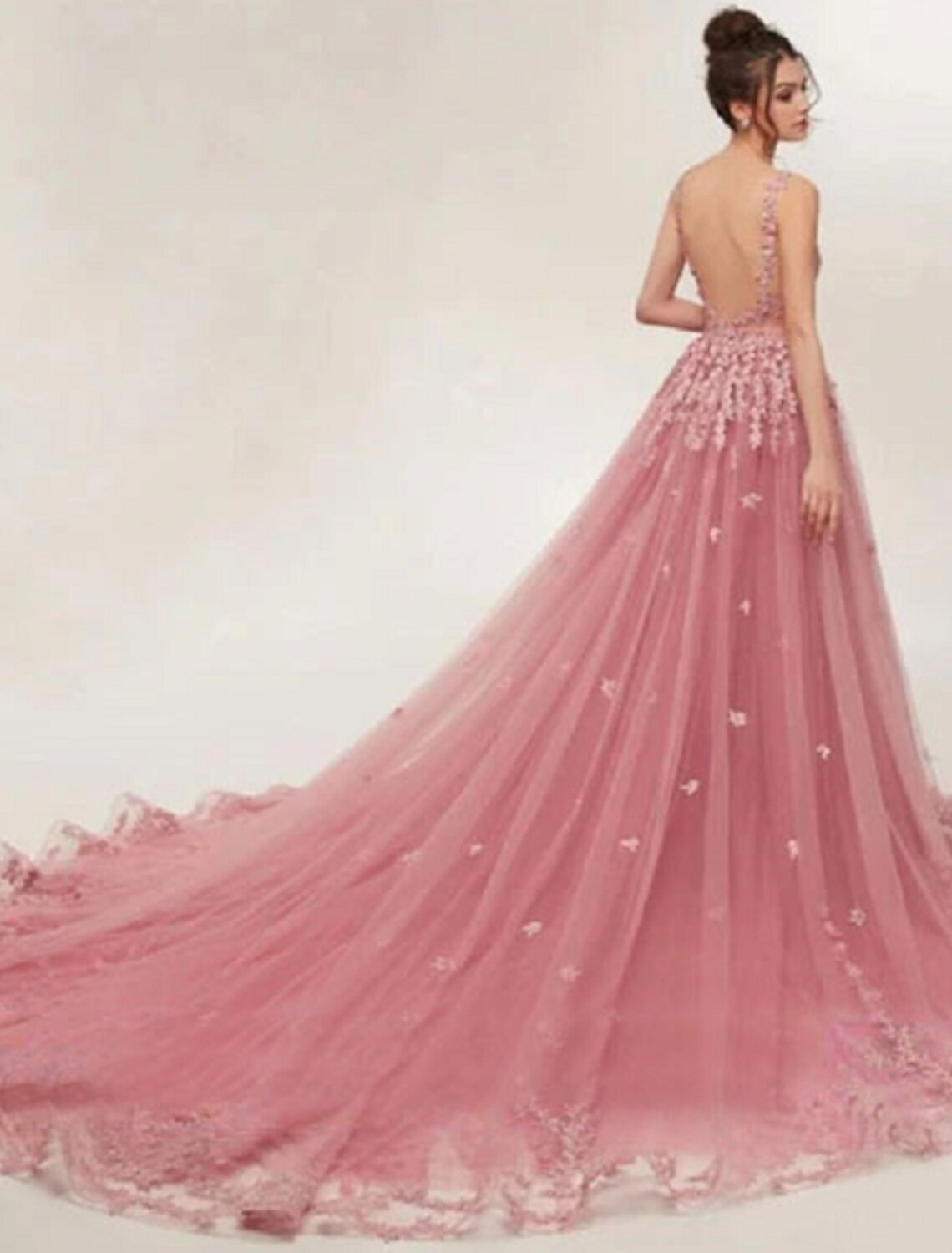 Elegant sleeveless ball gown with intricate appliques and flowing court train, side view.