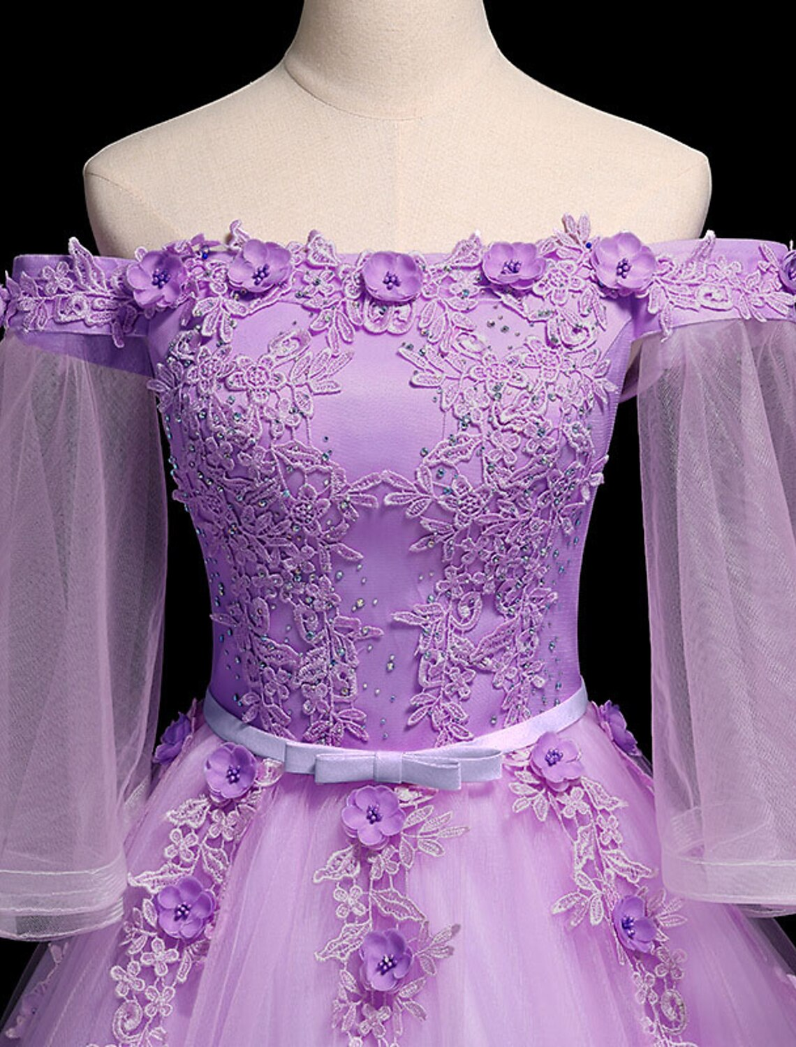 Side view of the elegant off-shoulder prom dress with intricate floral details.