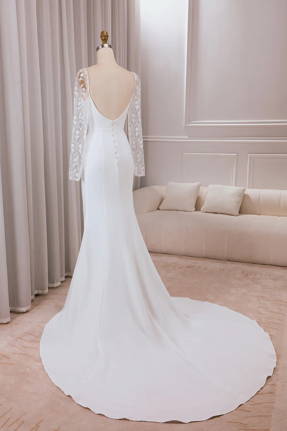 Back view of the ivory satin trumpet wedding dress, showing the elegant train.
