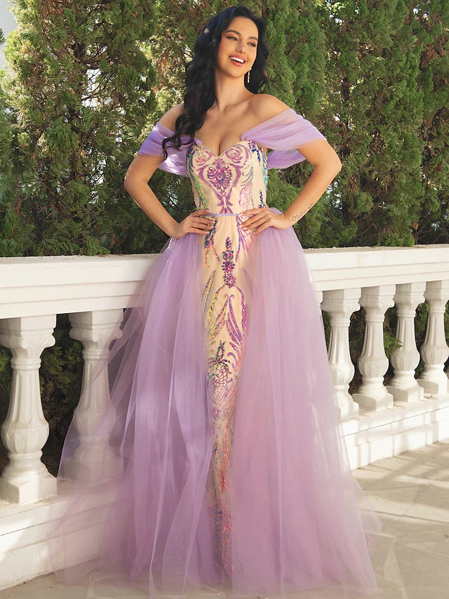 Model wearing a luxurious mermaid trumpet prom dress with V-neck and short sleeves.