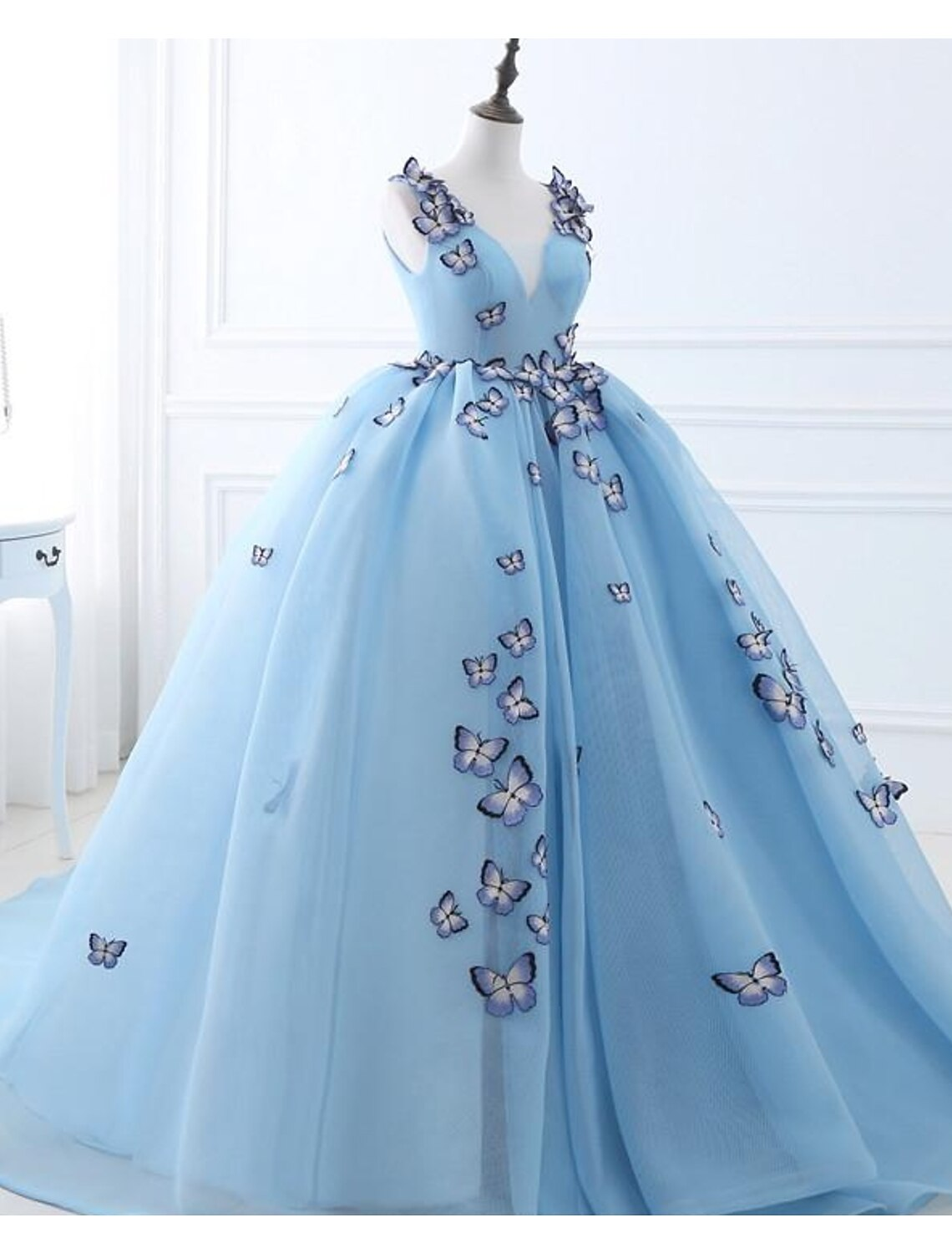 Back view of a luxurious ball gown featuring a court train and delicate appliques.