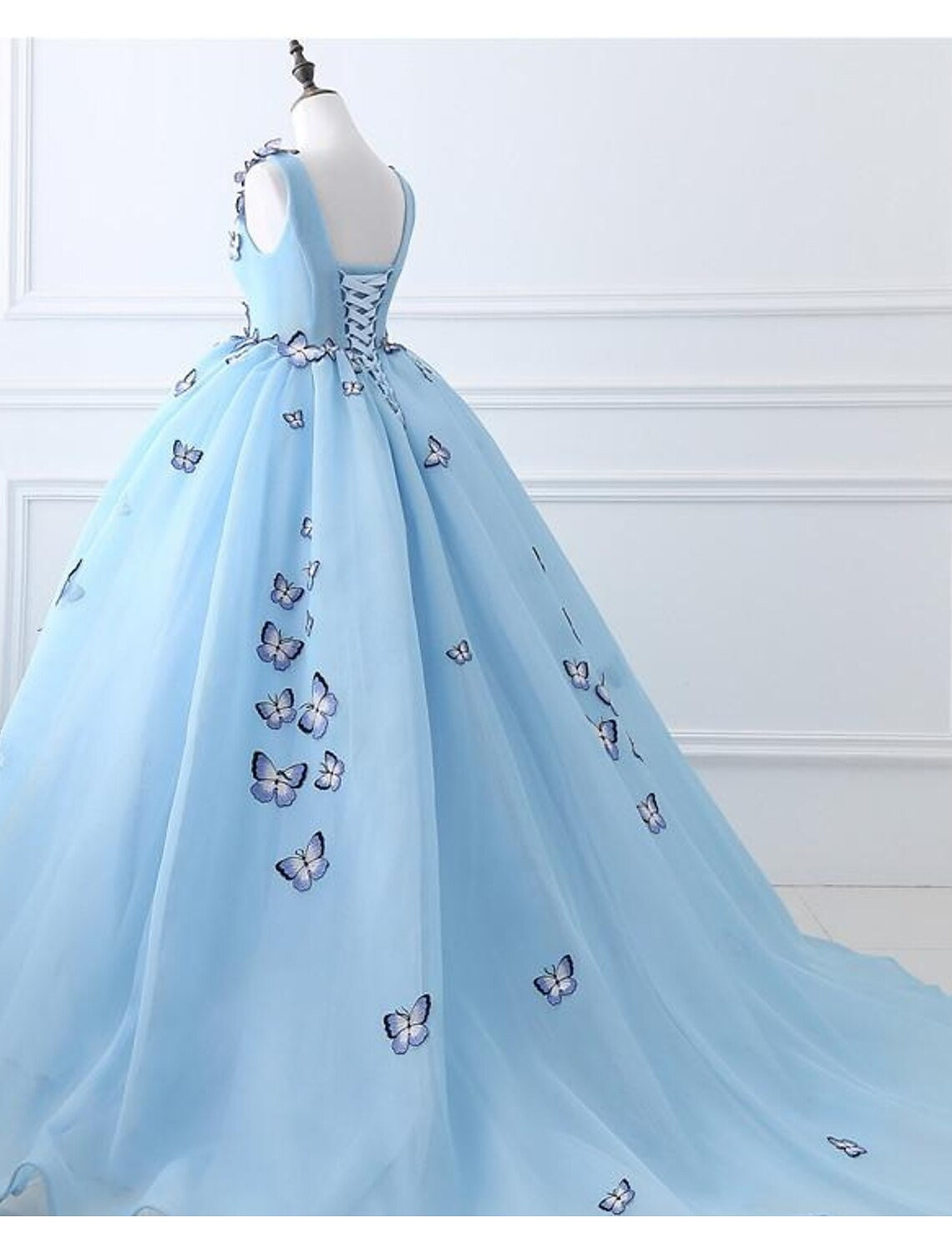 Close-up of the bodice and V-neckline of the ball gown with appliques.