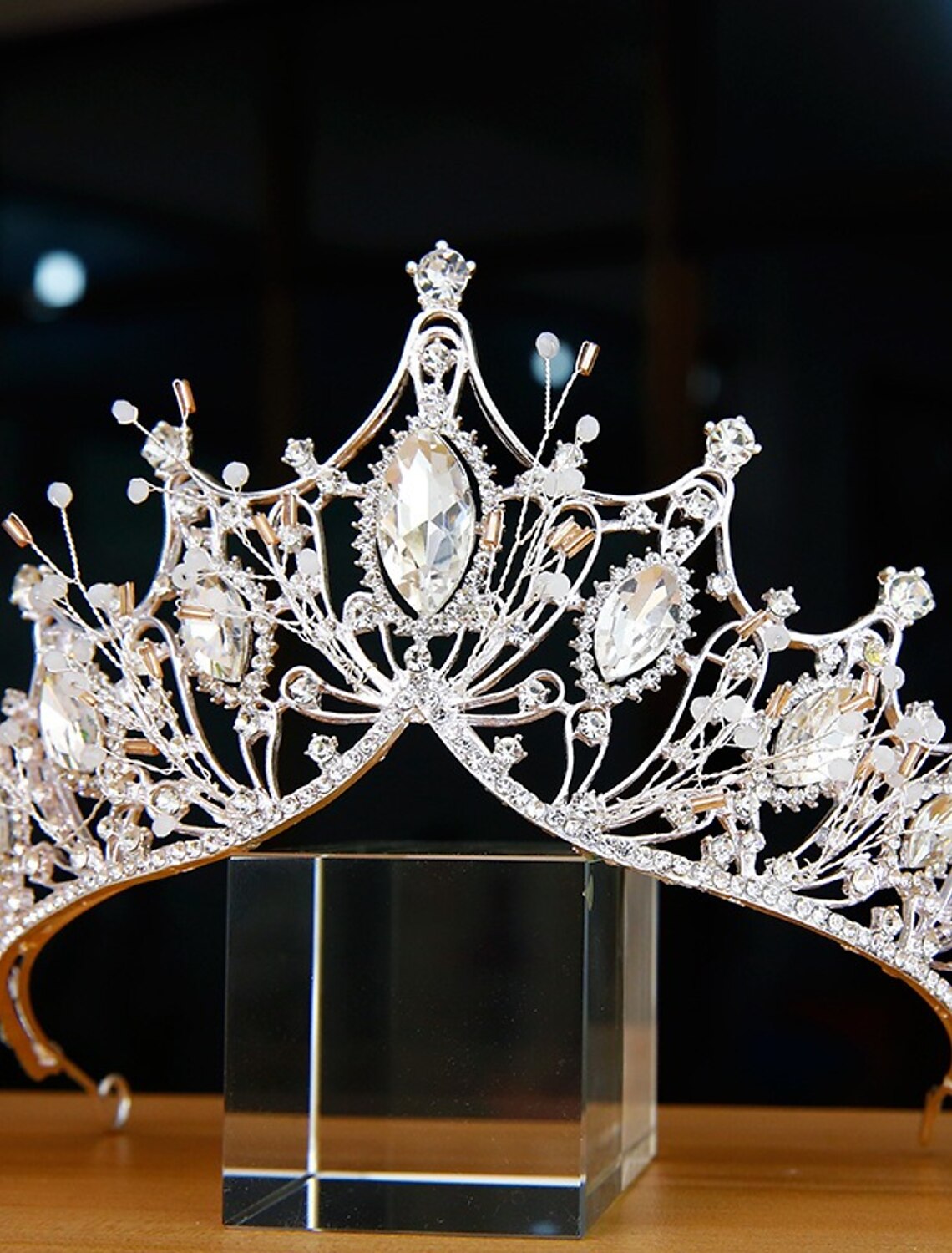 Side view of a princess-style headpiece adorned with pearls and sparkling rhinestones.