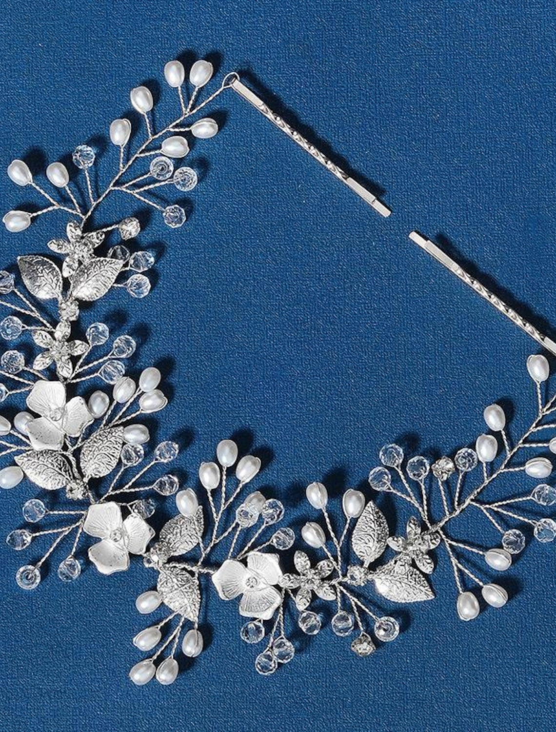 Luxury rhinestone and faux pearl crown tiara headband on a white background.