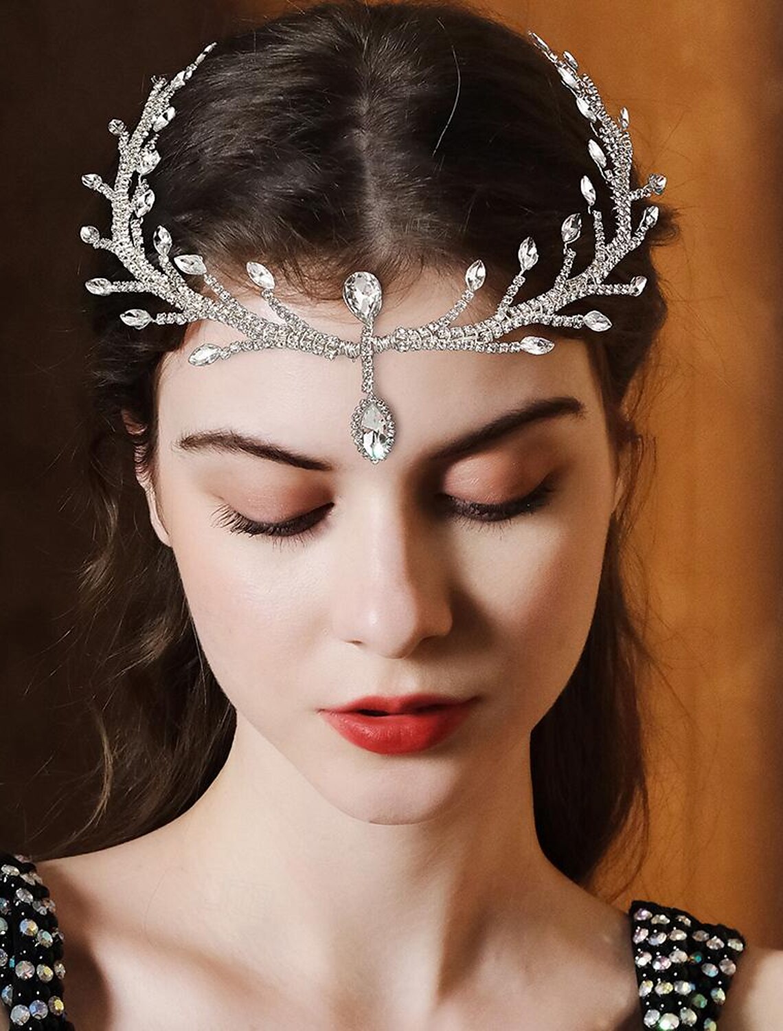 Close-up of a luxury rhinestone wedding tiara headband with sparkling crystals.