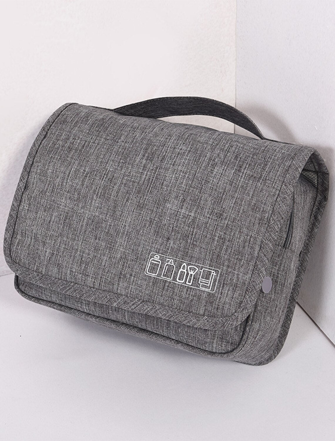 Front view of a men's black travel organizer bag.
