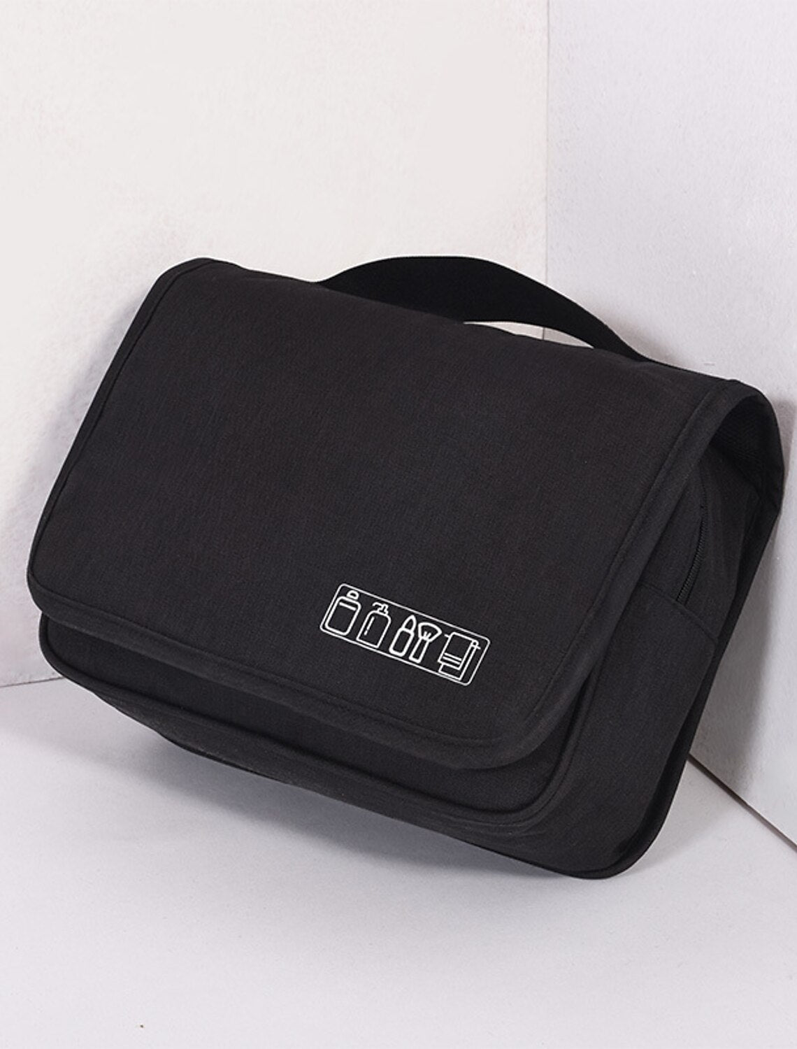Compact black shaving bag for travel.