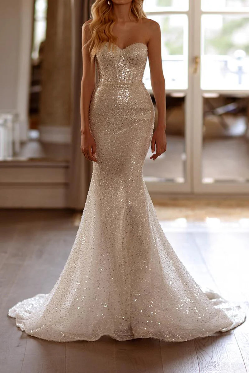 Front view of a bride wearing a Mermaid Boho Bridal Gown with detachable long sleeves.