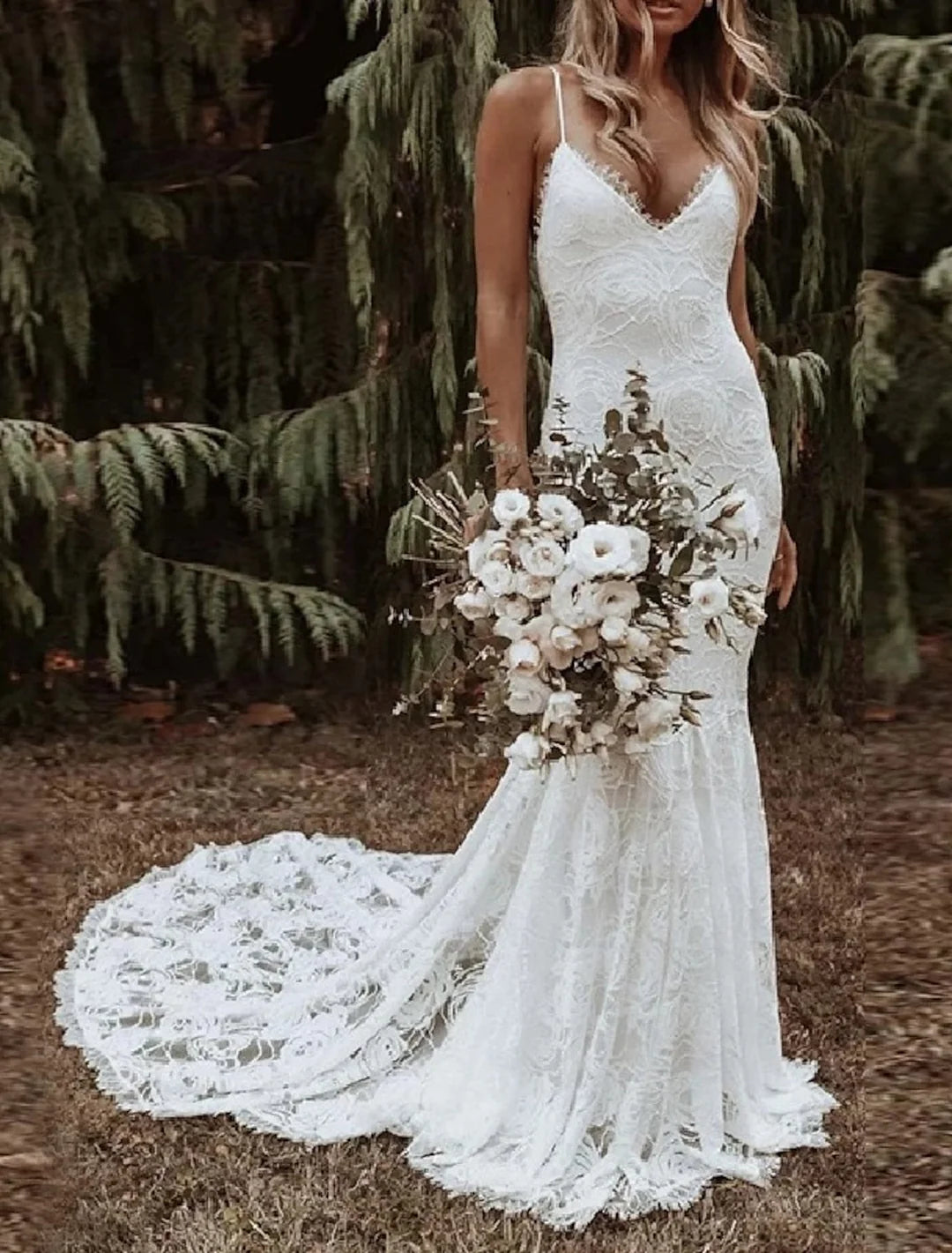 Elegant mermaid lace wedding dress with spaghetti straps.