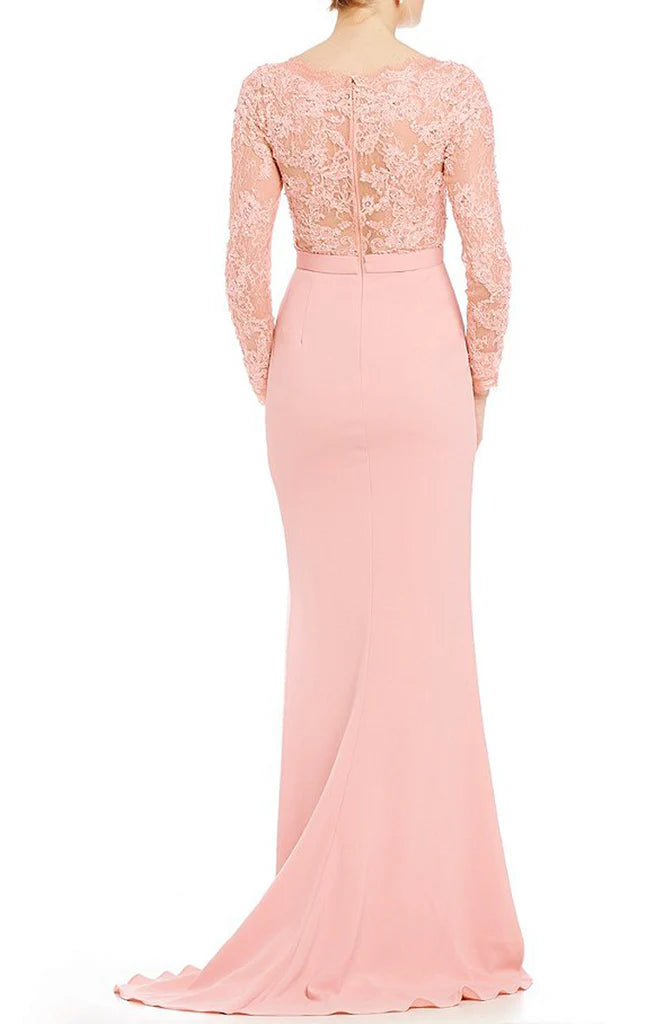 Side view of a woman in a sophisticated mermaid long sleeve formal gown.