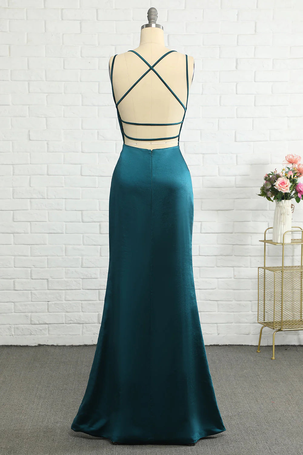 Back view of the mermaid prom dress, showing intricate peacock-like pattern and open back.