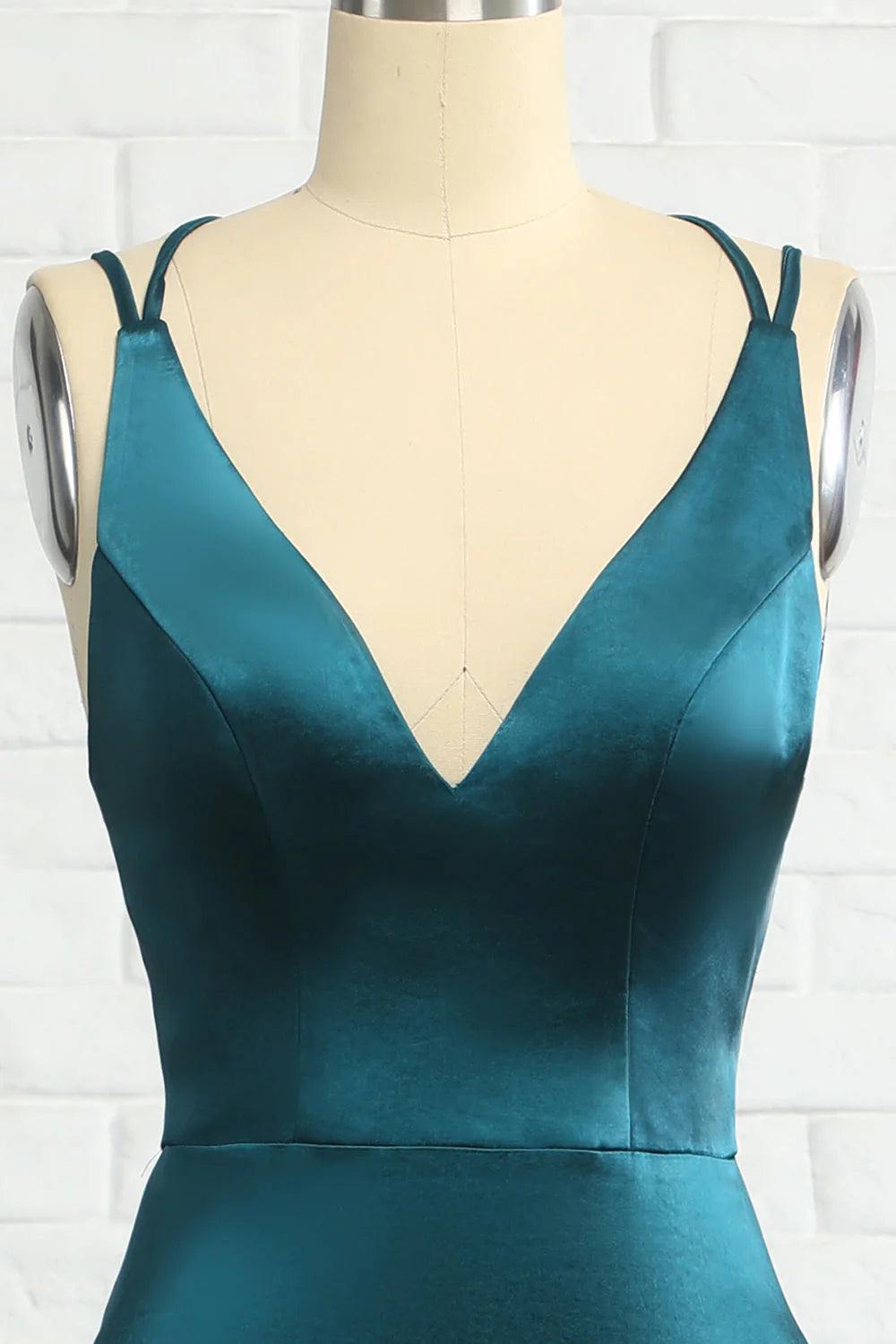 Side profile of the woman in the elegant mermaid prom dress with a long train.
