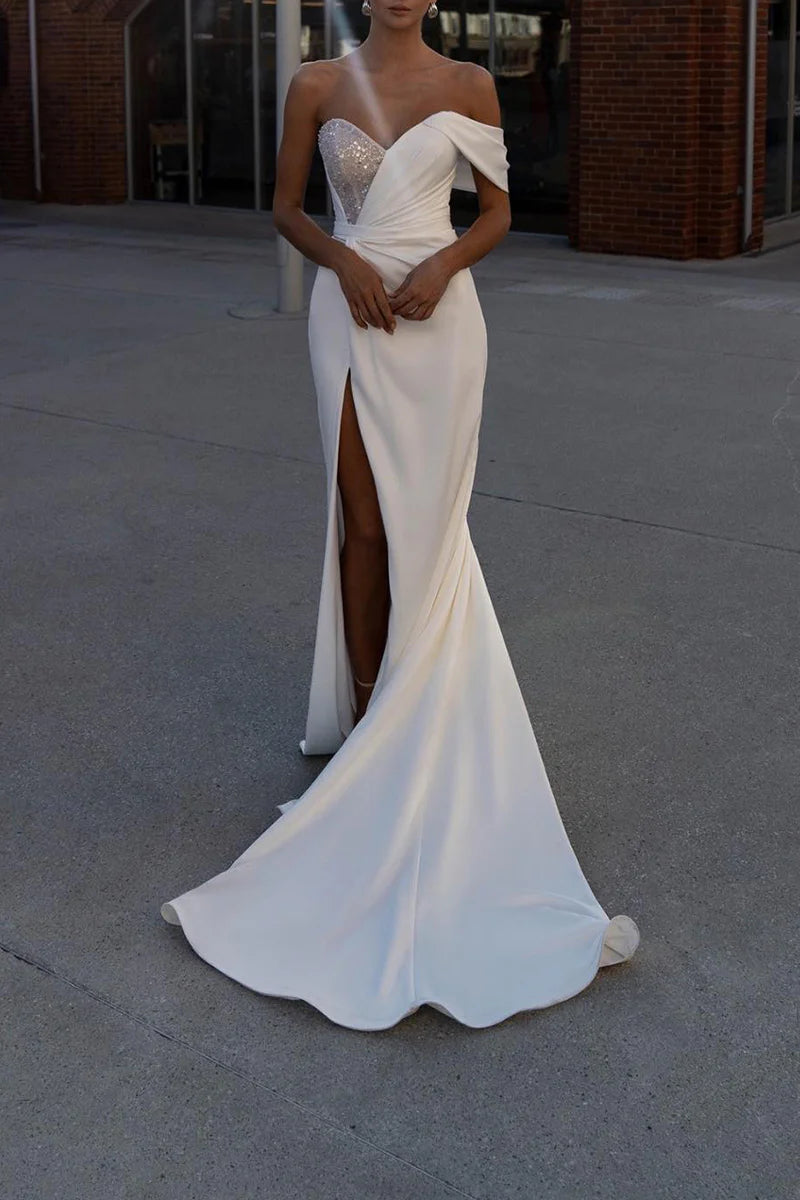 Elegant mermaid trumpet wedding dress with sweetheart neckline and side slit.