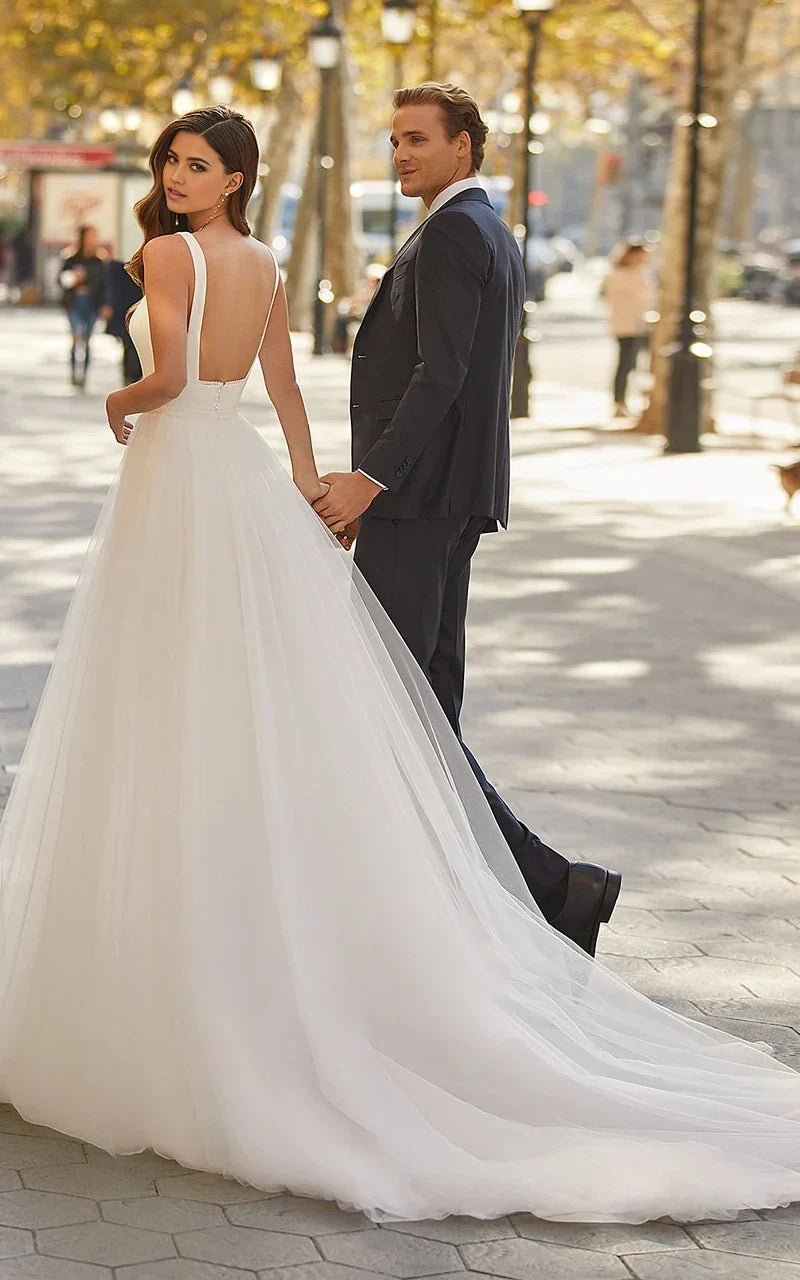 Back view of the A-line minimalist square neck tulle wedding dress, highlighting the sweep train.