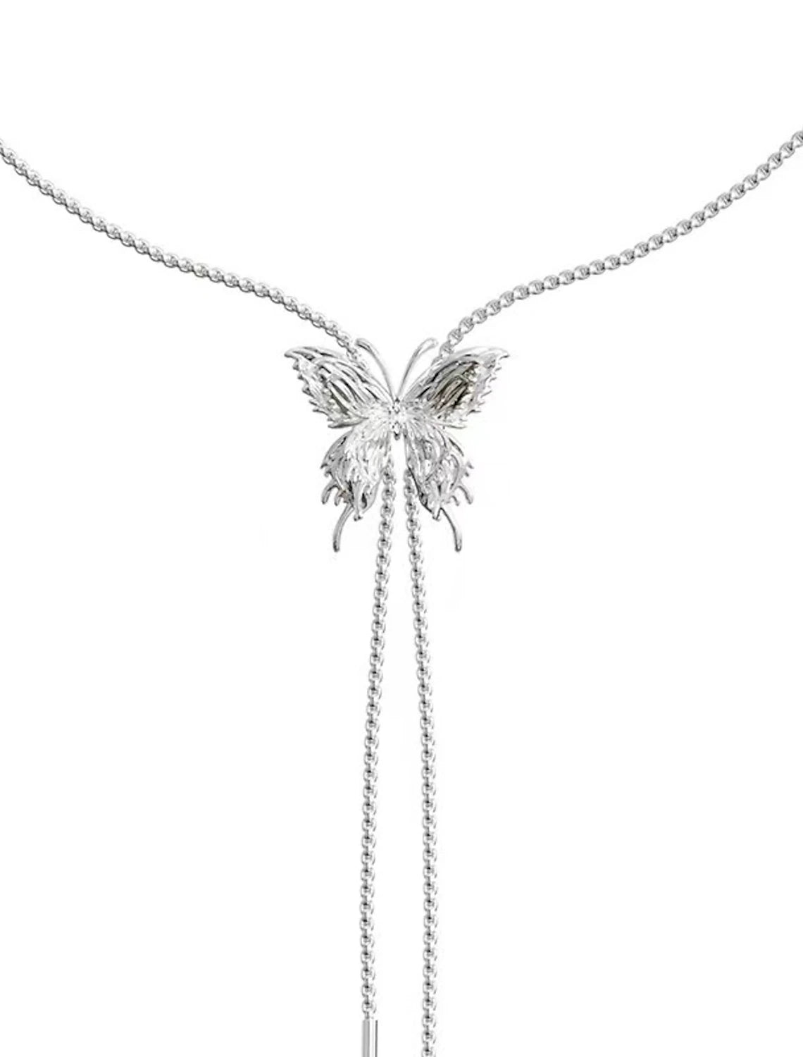 Detailed view of chrome tassel and butterfly elements on the necklace.