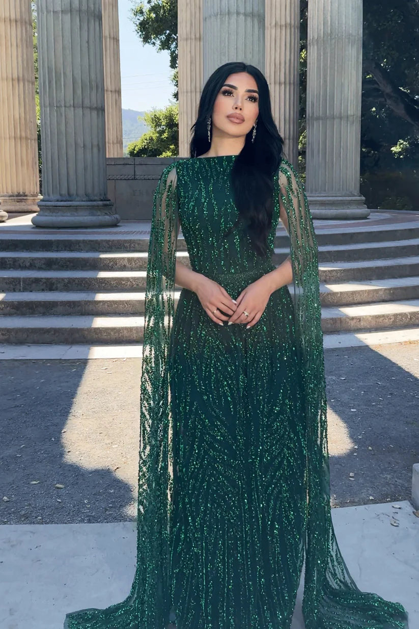 Woman wearing a modest A-line V-neck prom dress with embellished cape sleeves.