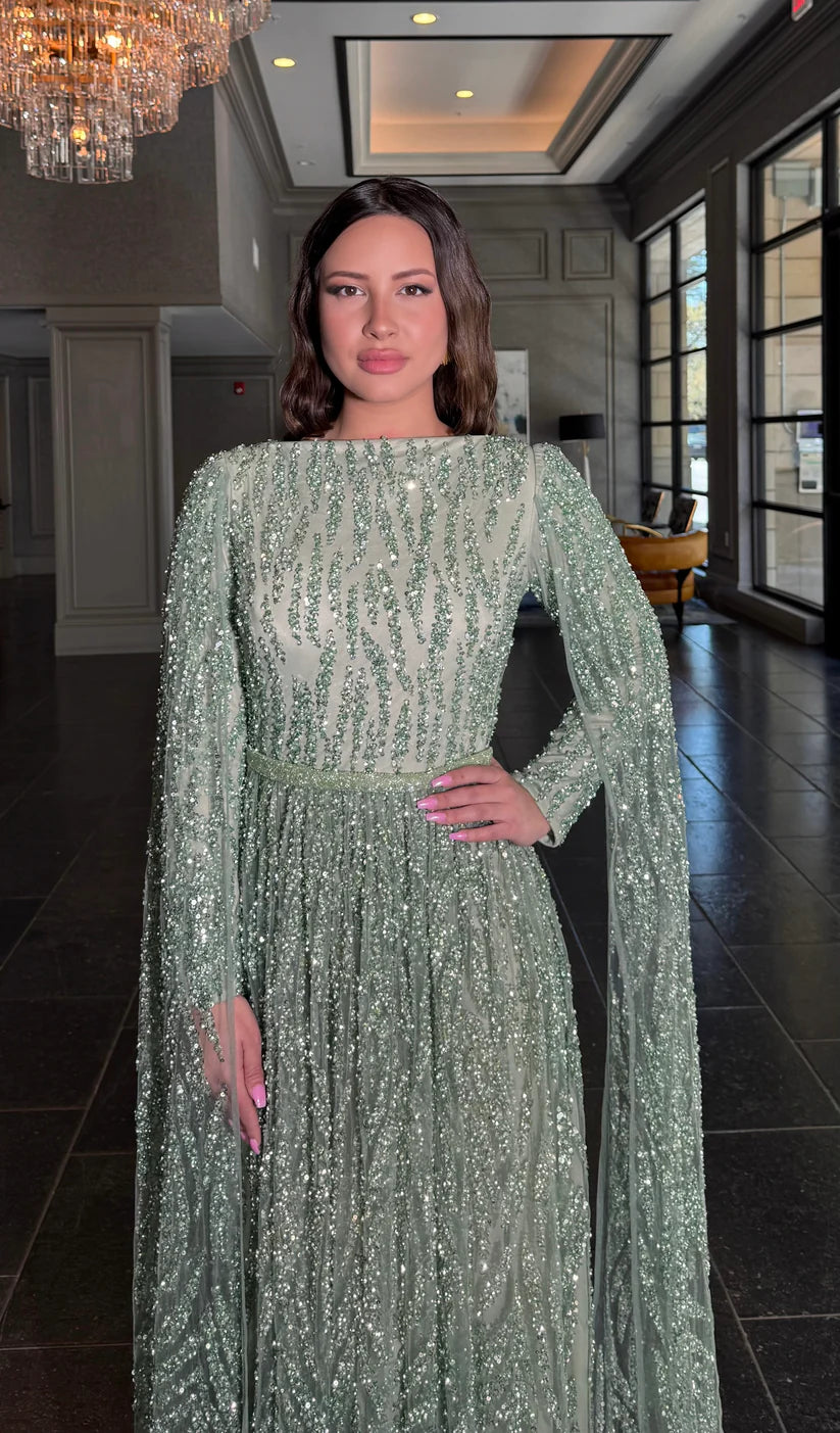 Side view of the embellished cape sleeve prom dress.