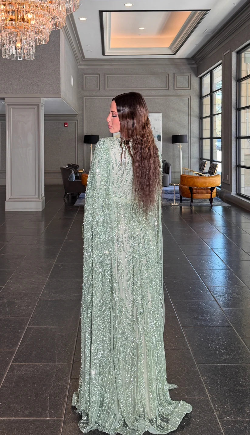 Close-up of the V-neck and embellished cape sleeve on the prom dress.