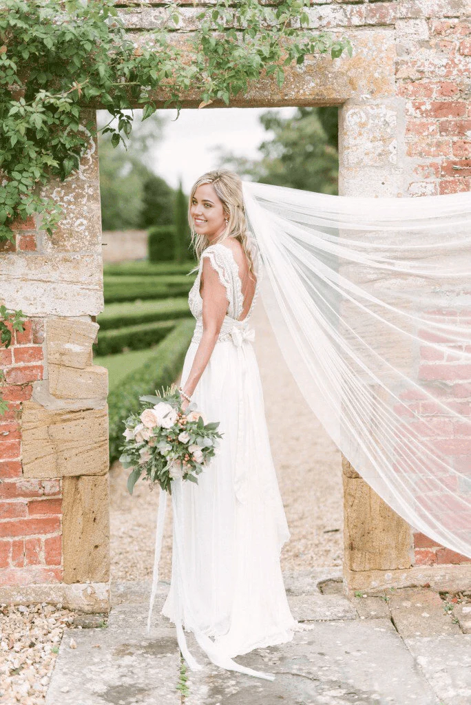 Modest A-line deep V-neck wedding gown with open back.