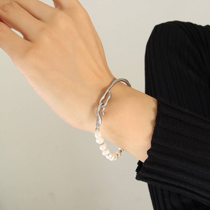 Close-up of natural freshwater pearls on a titanium steel bracelet.