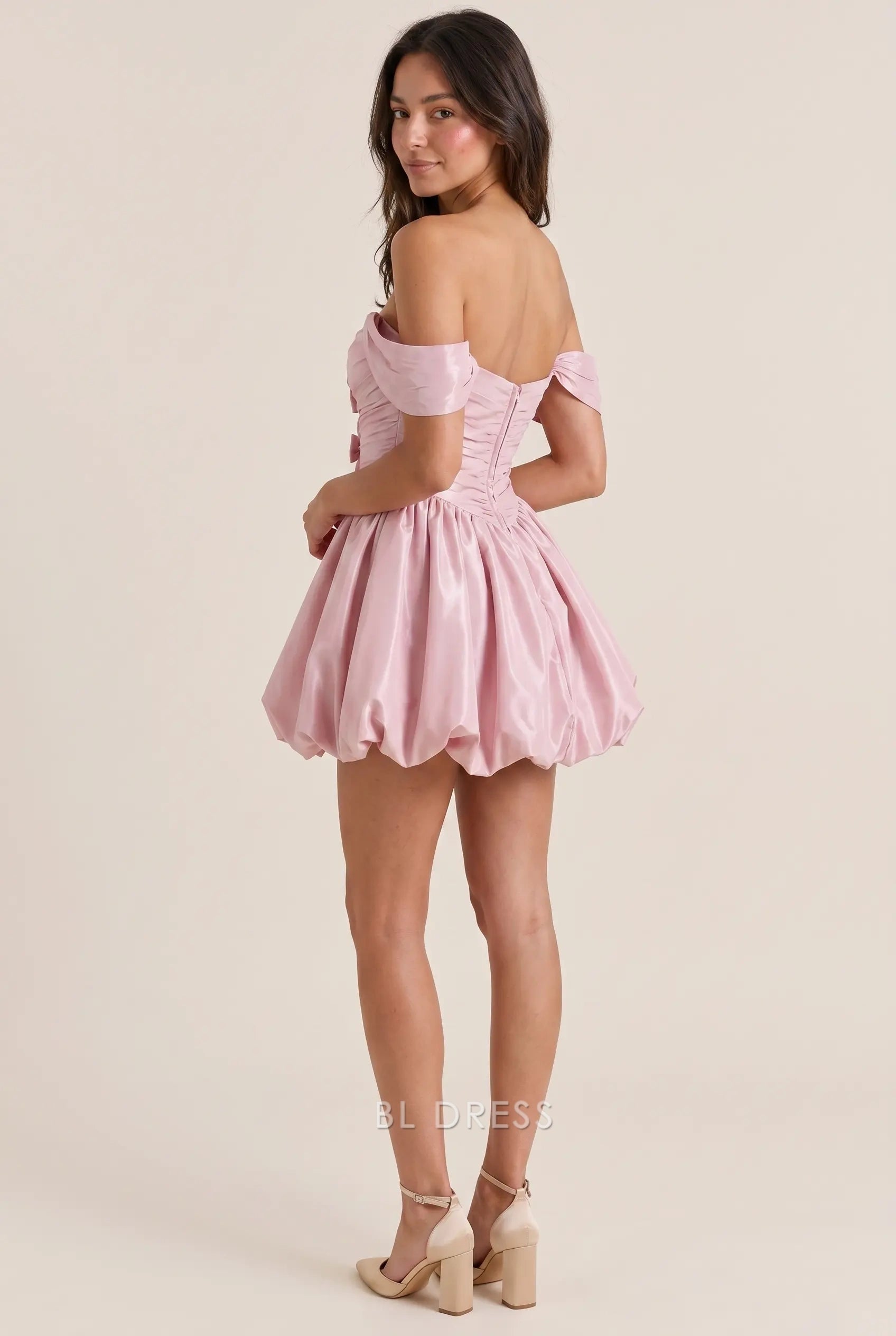 Side view of the BL Dress off-shoulder satin mini dress, showcasing the bubble hem skirt.