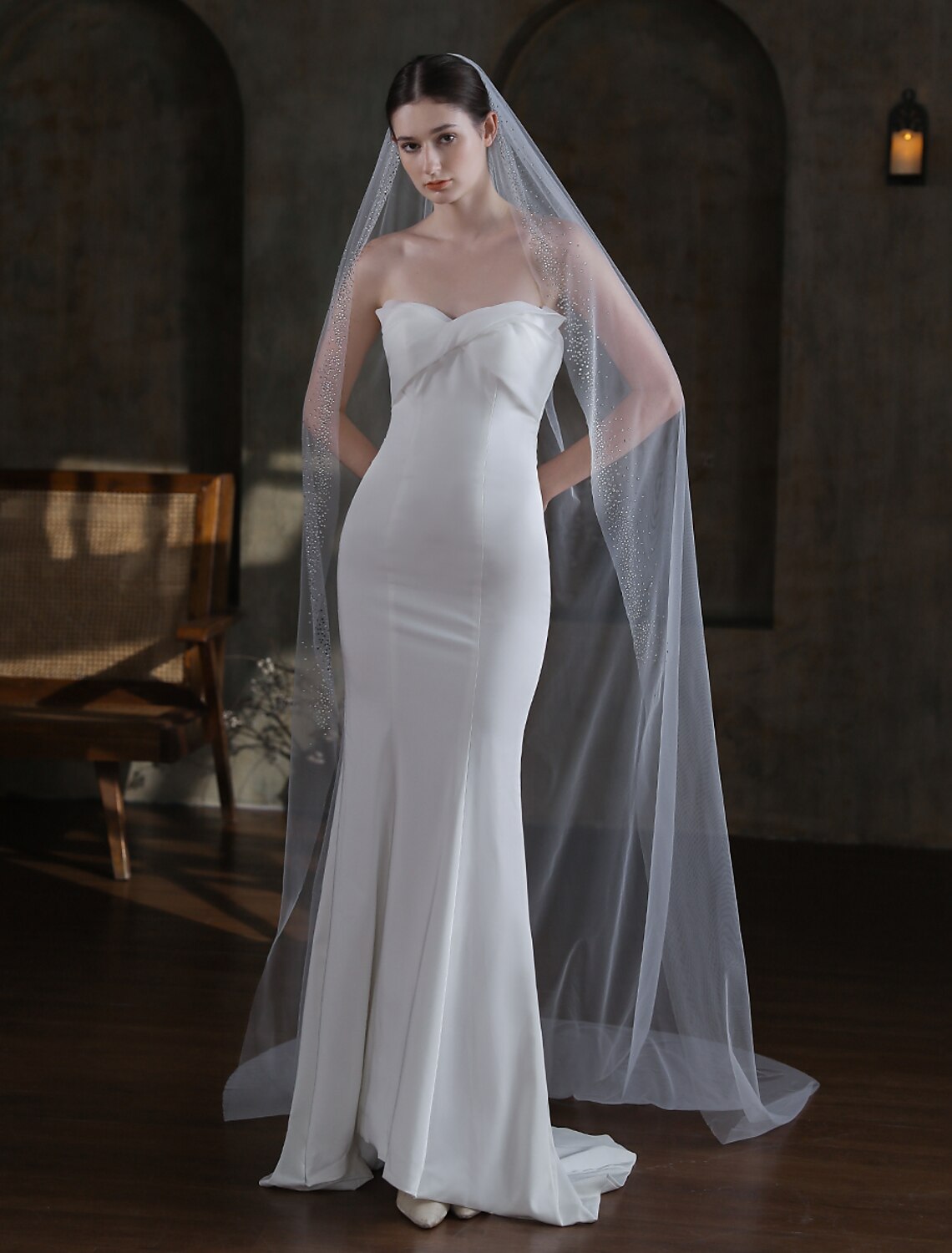 Bride wearing a long, sparkling one-tier cathedral wedding veil with glitter tulle.
