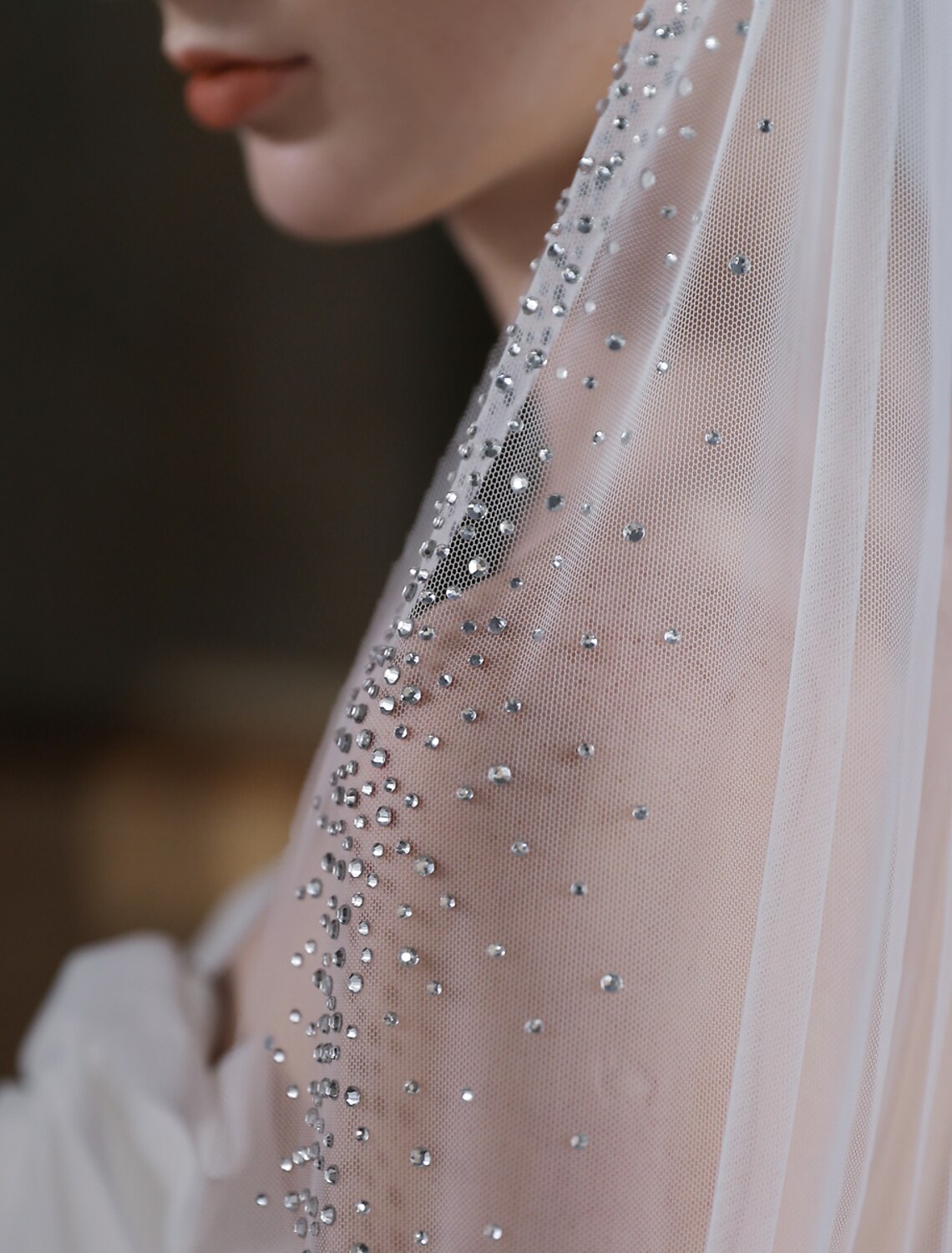 Bride walking, with the sparkling glitter tulle cathedral veil flowing gracefully behind her.